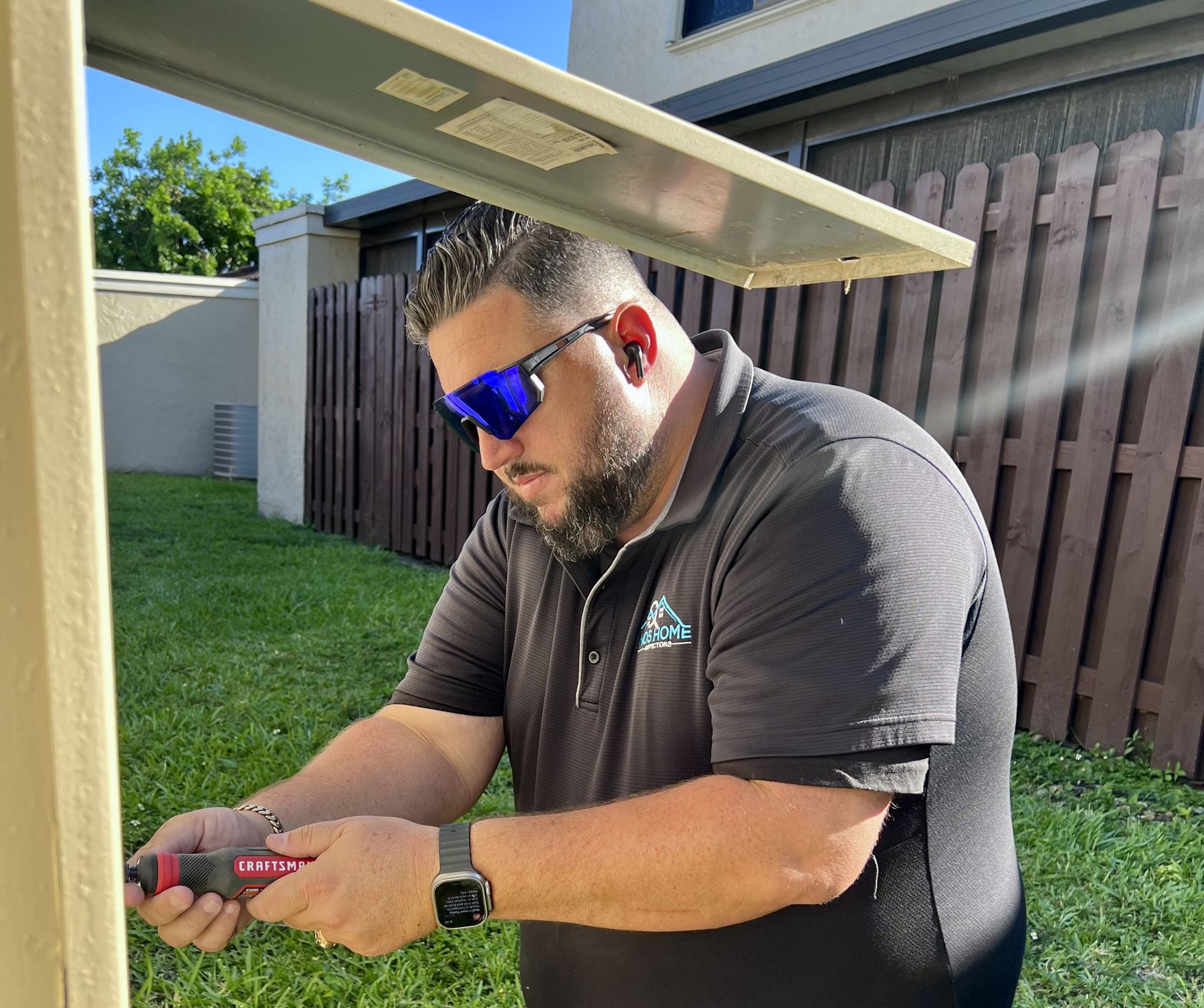 Inspector documenting a roof overhang
